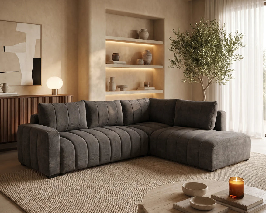 Divan lit sectionnel DARIO en tissu gris foncé, dans une chambre contemporaine