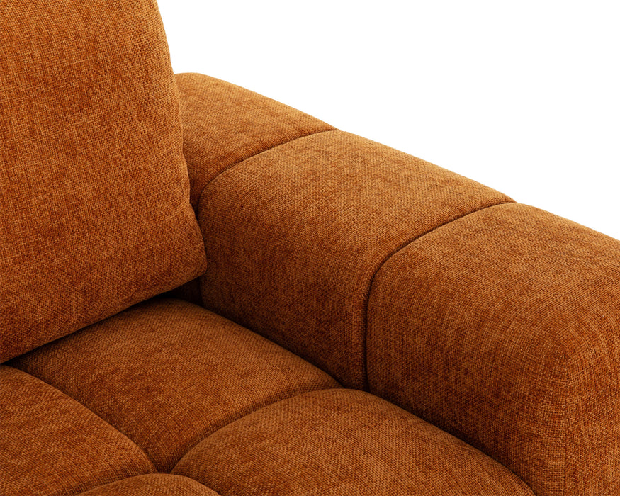 Gros plan sur le tissu polyester texturé orange du divan Olivia