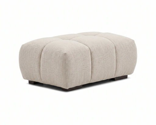 Ottoman capitonné OLIVIA beige crème avec pieds noirs, vue en angle