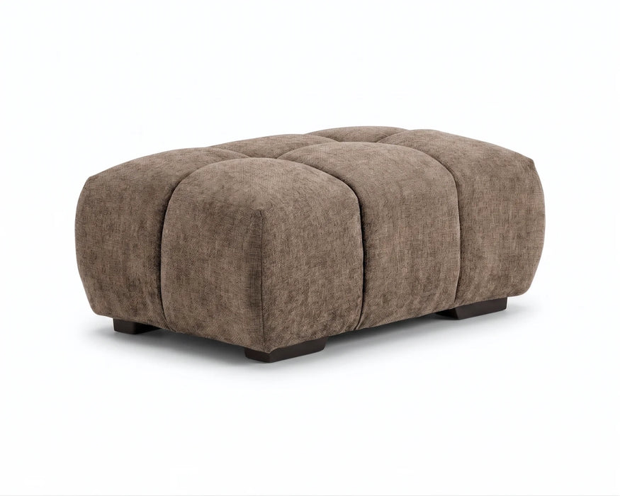 Ottoman capitonné OLIVIA taupe avec pieds noirs, vue en angle